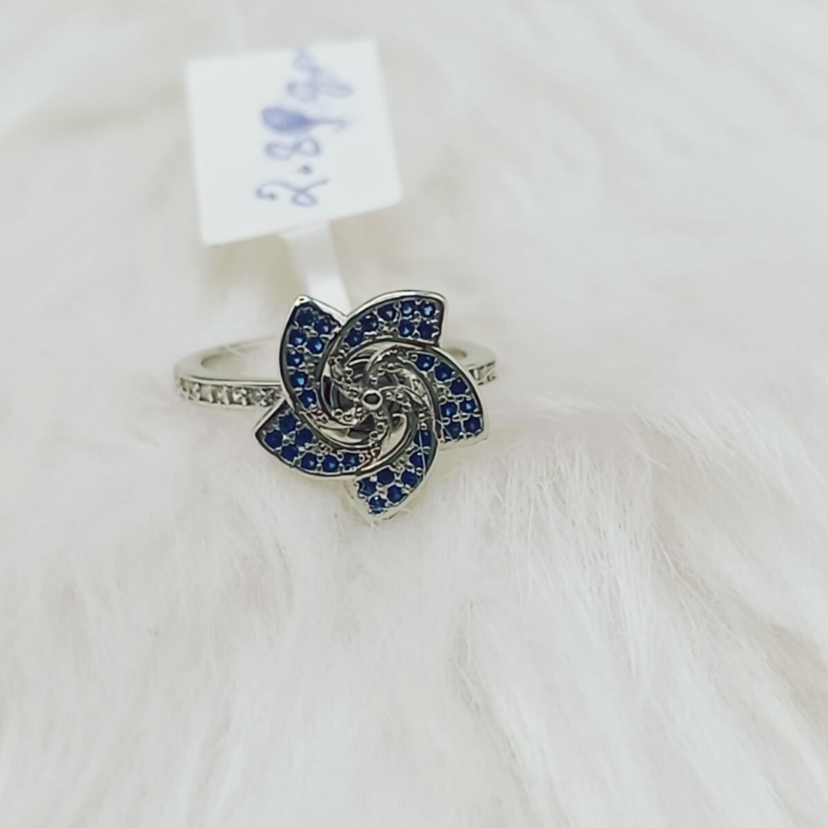 Discover the Elegance of Our Sterling Silver Floral Share Blue Stone Rotating Women's Ring